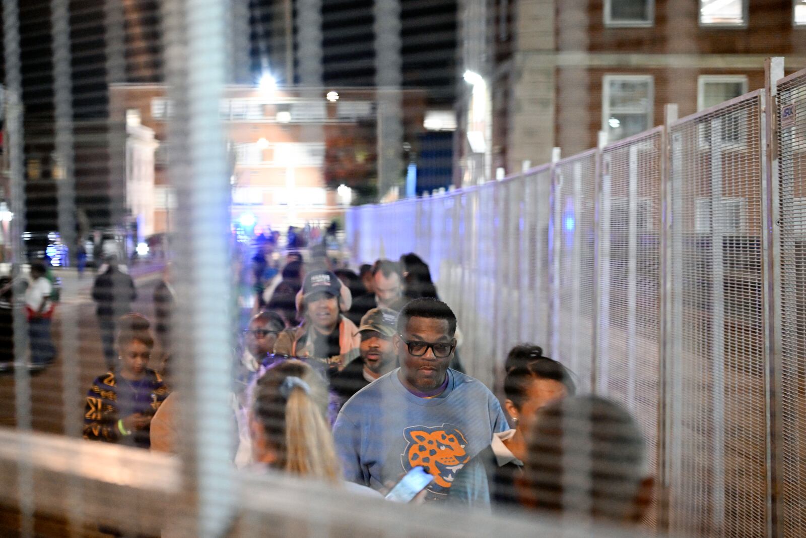 Attendees of Vice President Kamala Harris' presidential rally enter the venue at Howard University in a secure gated entrance, Tuesday, Nov. 5, 2024, in Washington. (AP Photo/Terrance Williams)