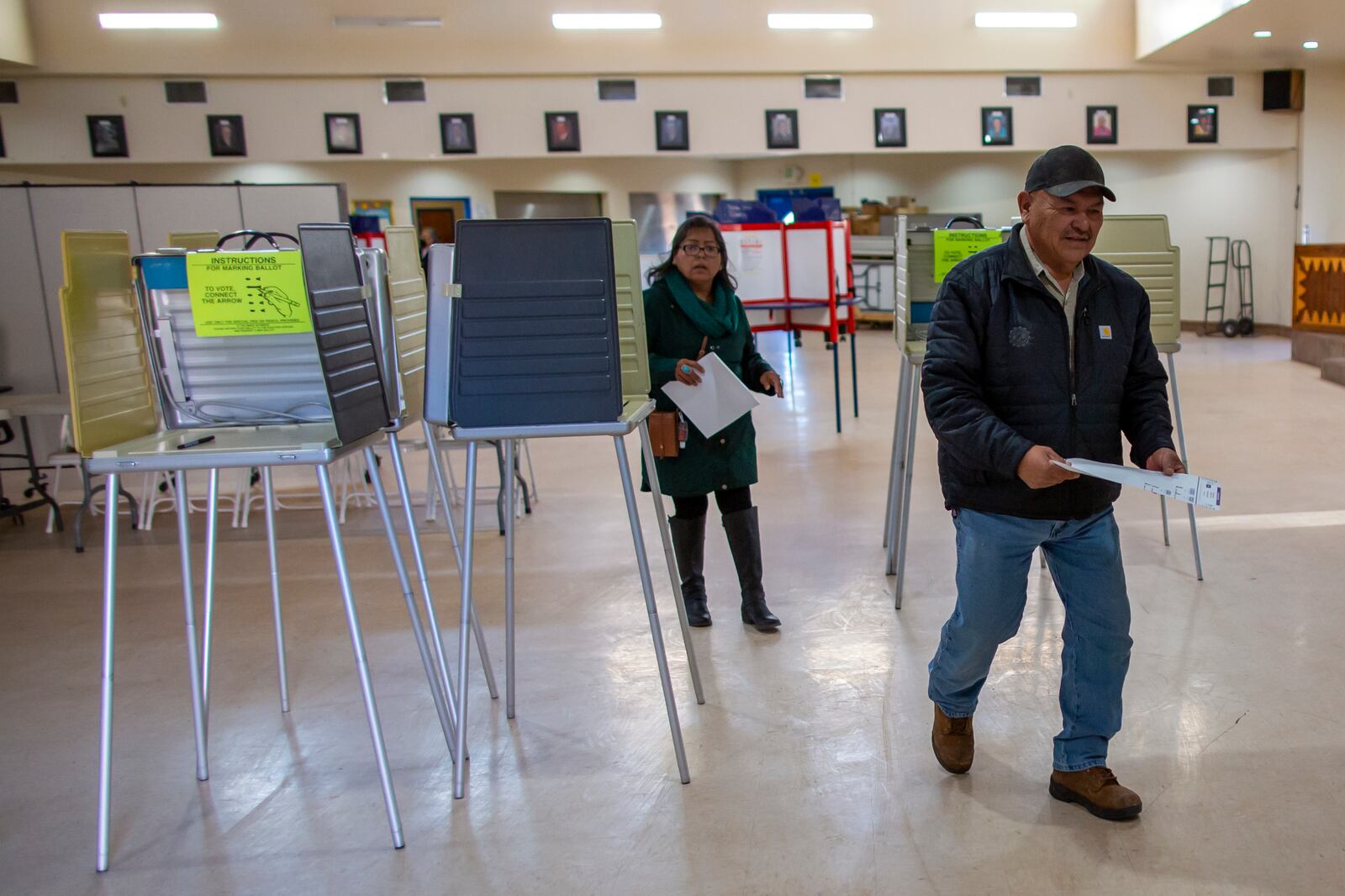 Voters look for the tabulation machine after marking their ballots at a polling station on the Navajo Nation in Fort Defiance, Ariz., on Election Day, Tuesday, Nov. 5, 2024. (AP Photo/Andres Leighton)