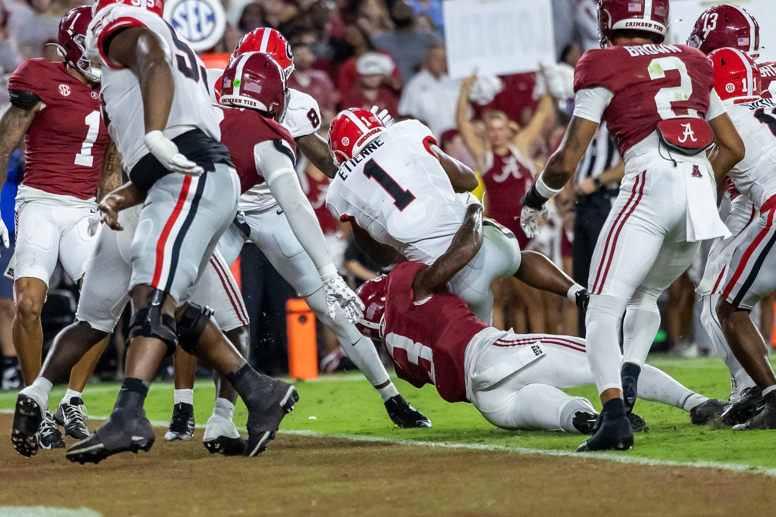 Georgia running back Trevor Etienne (1) scores a touchdown on a run over Alabama defensive back Keon Sabb (3) during the first half of an NCAA college football game, Saturday, Sept. 28, 2024, in Tuscaloosa, Ala. (AP Photo/Vasha Hunt)