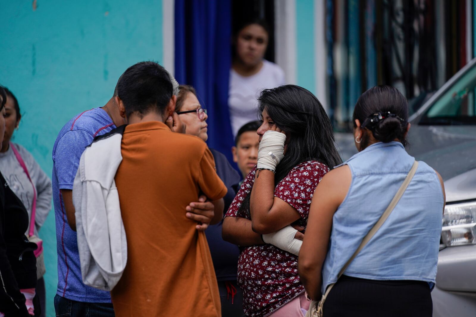 Estrella Bejarano, second from right, the mother of two children who died after a rain-induced landslide, speaks with relatives in Naucalpan, Mexico, Tuesday, Sept. 17, 2024. (AP Photo/Felix Marquez)