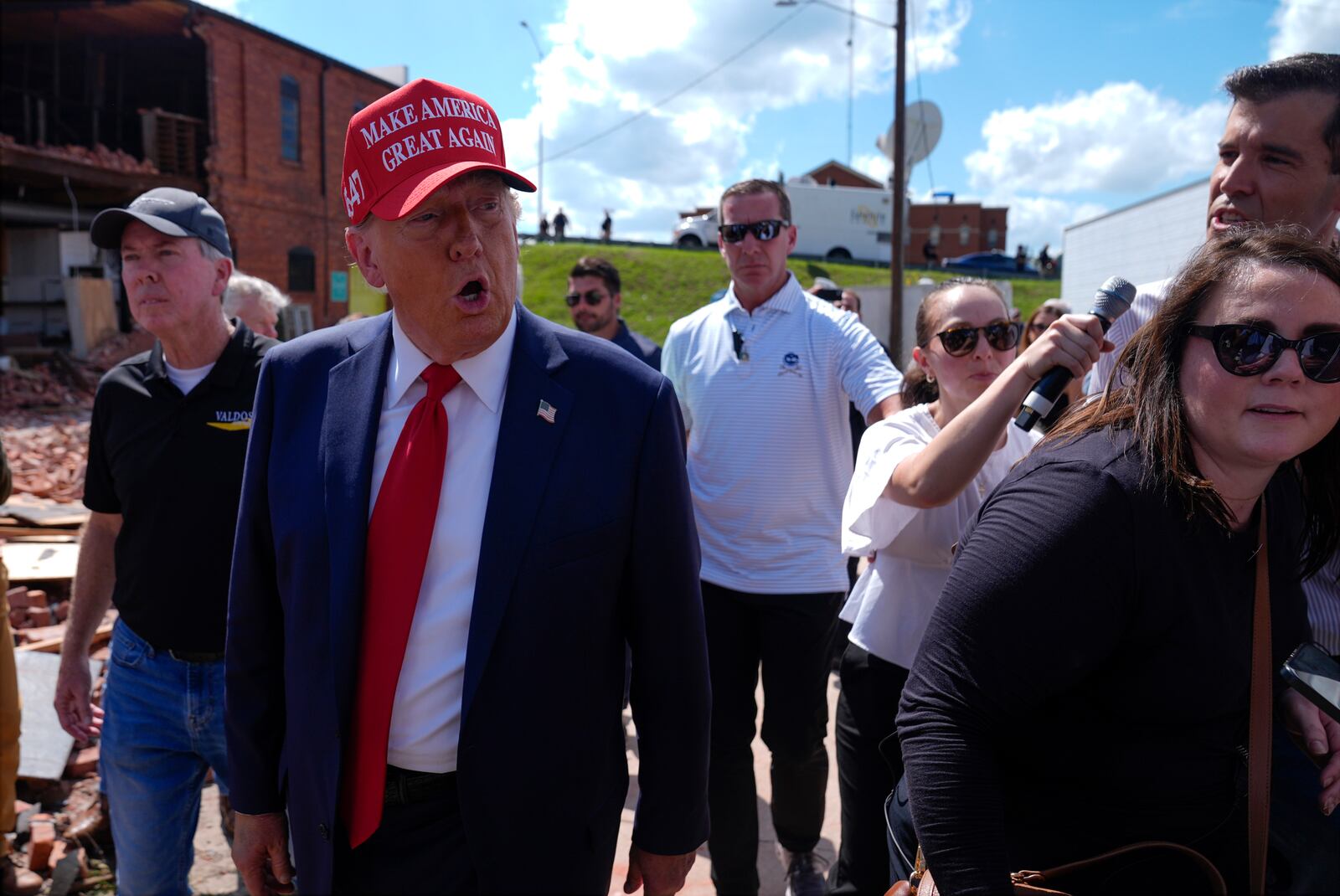 Republican presidential nominee former President Donald Trump walks outside the Chez What furniture store as he visits Valdosta, Ga., a town impacted by Hurricane Helene, Monday, Sept. 30, 2024. (AP Photo/Evan Vucci)