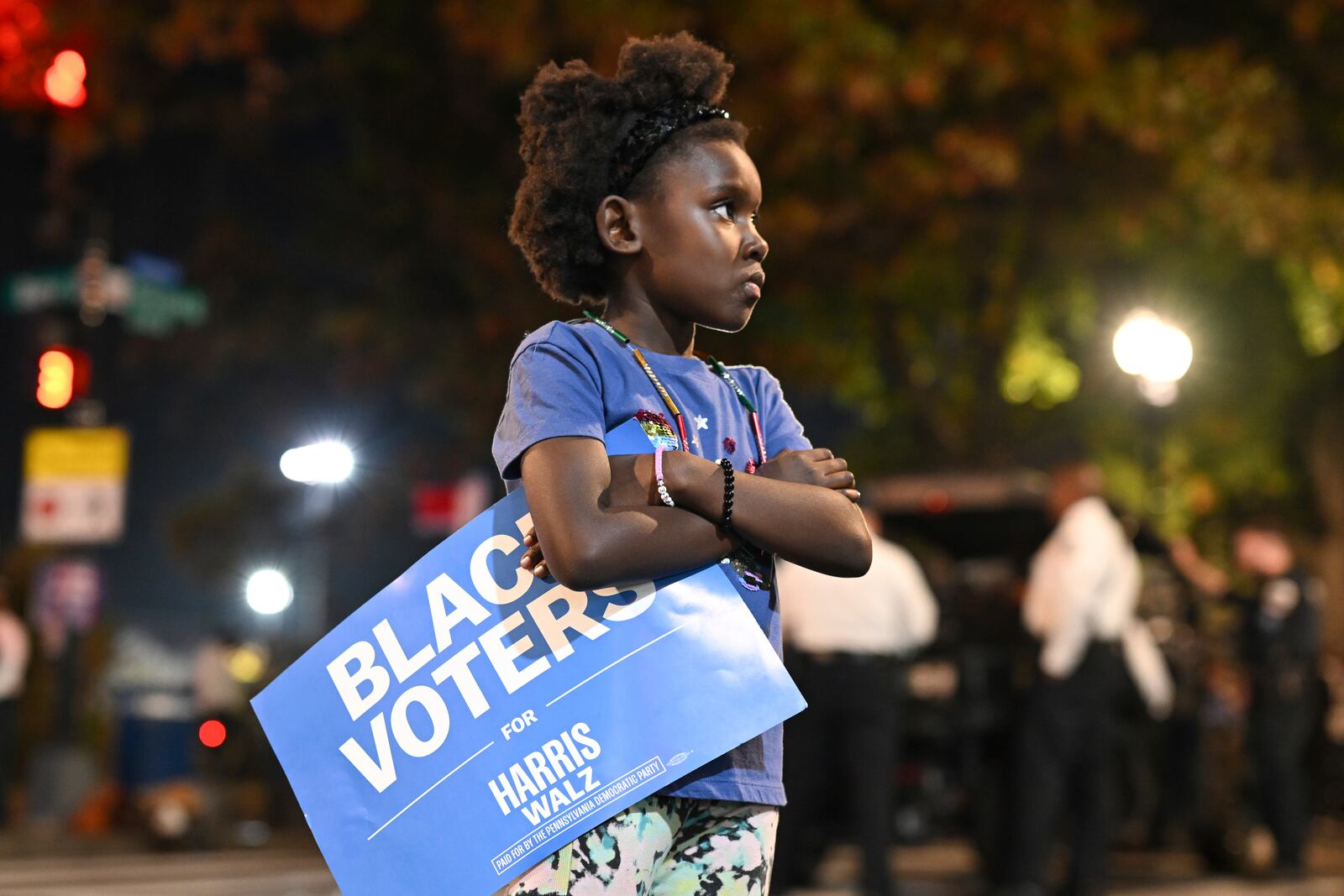 A young girl holds a "Black Voters for Harris-Walz" sign outside of Democratic presidential nominee Vice President Kamala Harris' election night watch party at Howard University, Tuesday, Nov. 5, 2024, in Washington. (AP Photo/Terrance Williams)