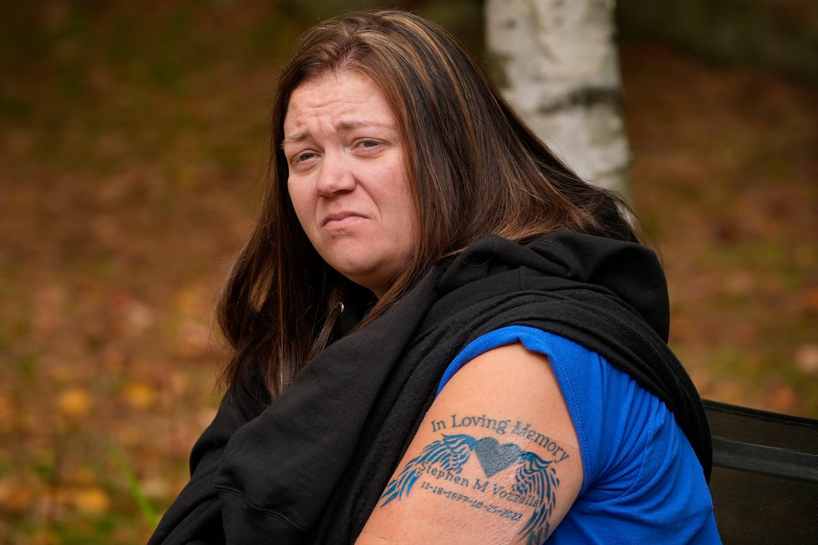 Megan Vozzella shows a tattoo she got in memory of her late husband, Stephen Vozzella, who was one of the people killed in a mass shooting on Oct. 25, 2023, in Lewiston, Tuesday, Oct. 1, 2024, in Oxford, Maine. (AP Photo/Robert F. Bukaty)