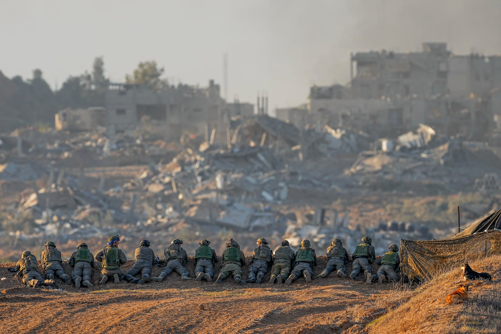 FILE - Israeli soldiers take positions near the border with Gaza in southern Israel, on Dec. 11, 2023. (AP Photo/Ohad Zwigenberg, File)