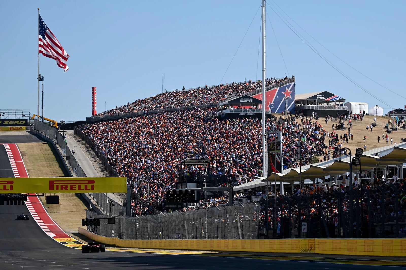 Fans watch as drivers race in the F1 U.S. Grand Prix auto race at the Circuit of the Americas, Sunday, Oct. 20, 2024, in Austin, Texas. (Patrick Fallon/Pool Photo via AP)