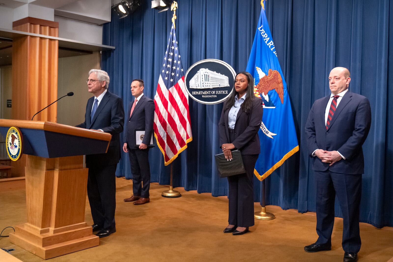 Attorney General Merrick Garland, left, speaks during a news conference at the Department of Justice, Tuesday, Sept. 24, 2024, in Washington. (AP Photo/Mark Schiefelbein)