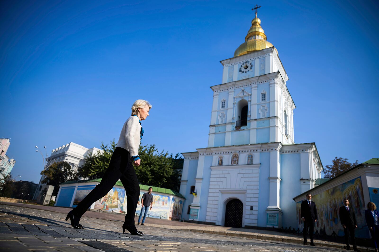 President of the European Commission Ursula von der Leyen, left, walks past St. Michael's Monastery on her way to visit a memorial wall commemorating the fallen Ukrainian soldiers in the war with Russia, in Kyiv, Ukraine, Friday, Sept. 20, 2024. (Christoph Soeder, Pool via AP)