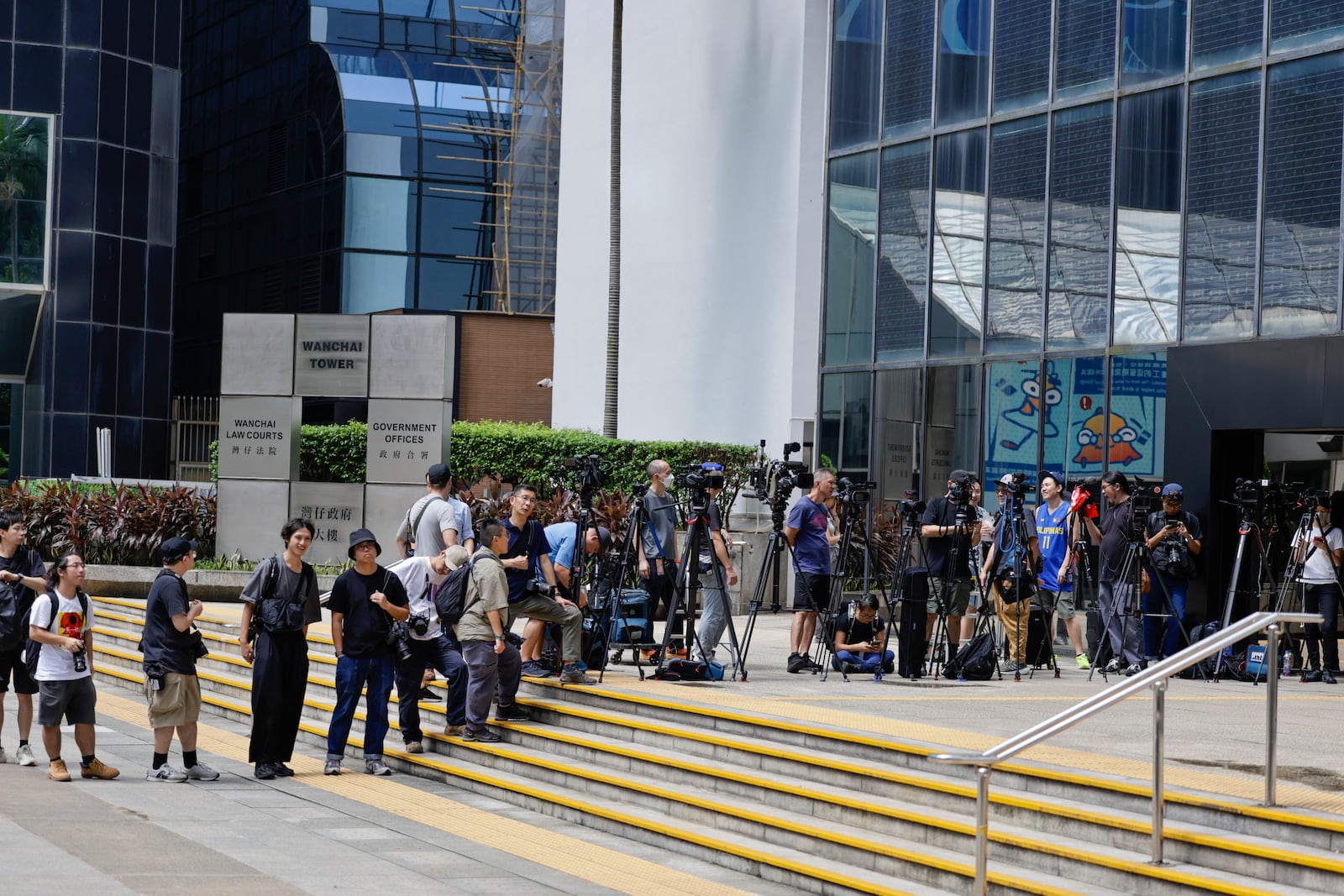 Media line up outside the District Court in Wan Chai, Hong Kong, ahead of a sentencing hearing for two former Stand News editors convicted of sedition, Thursday, Sept. 26, 2024. (AP Photo/May James)