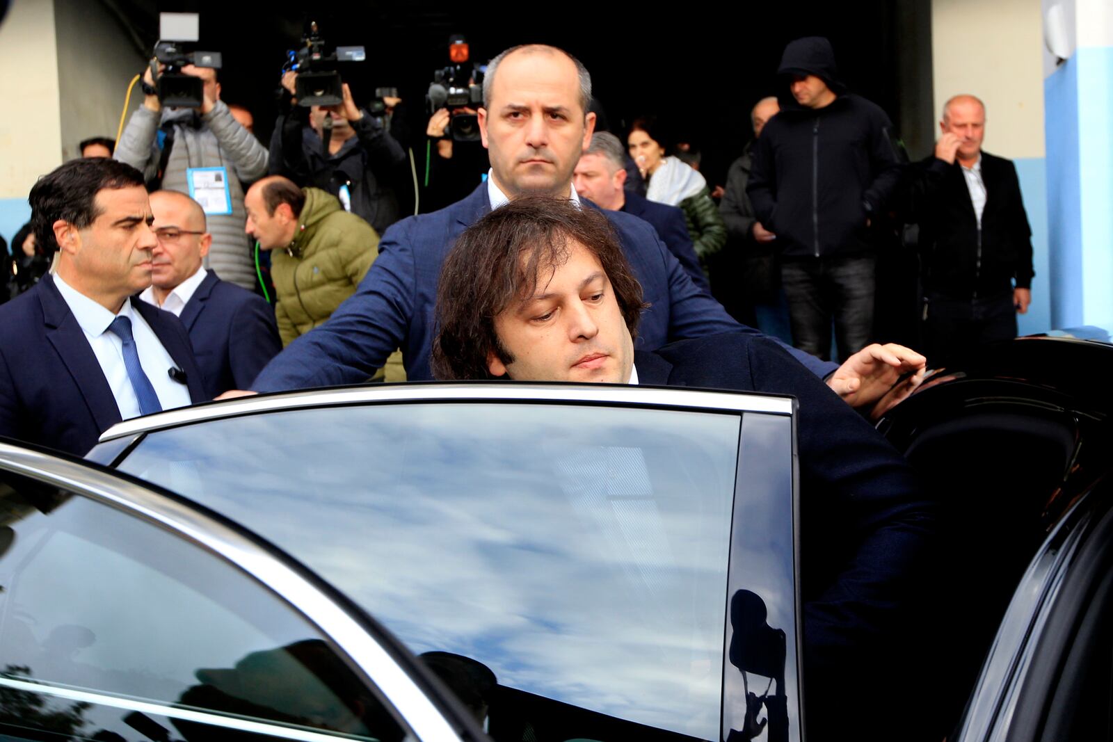 Georgian Prime Minister Irakli Kobakhidze gets into a car after voting at a polling station during the parliamentary election in Tbilisi, Georgia, Saturday, Oct. 26, 2024. (AP Photo/Shakh Aivazov)