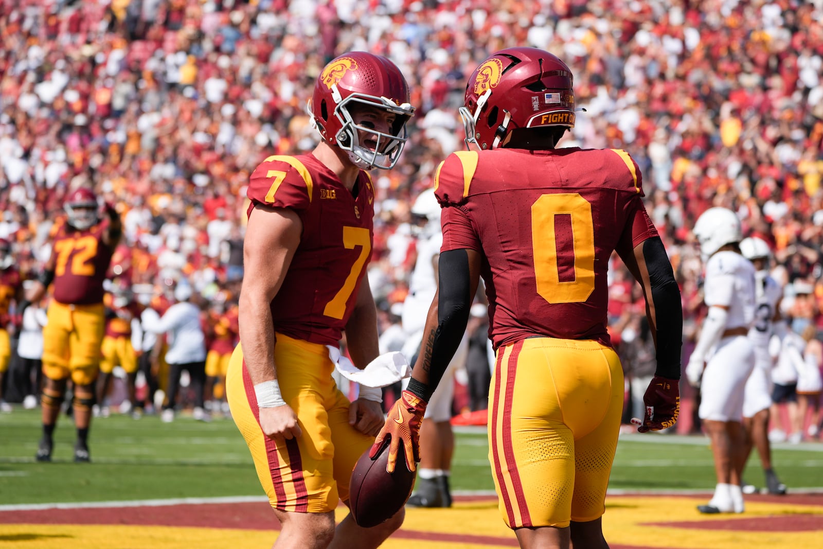 Southern California quarterback Miller Moss (7), left, celebrates after throwing a touchdown pass to running back Quinten Joyner (0) during the first half of an NCAA college football game against Penn State, Saturday, Oct. 12, 2024, in Los Angeles. (AP Photo/Marcio Jose Sanchez)