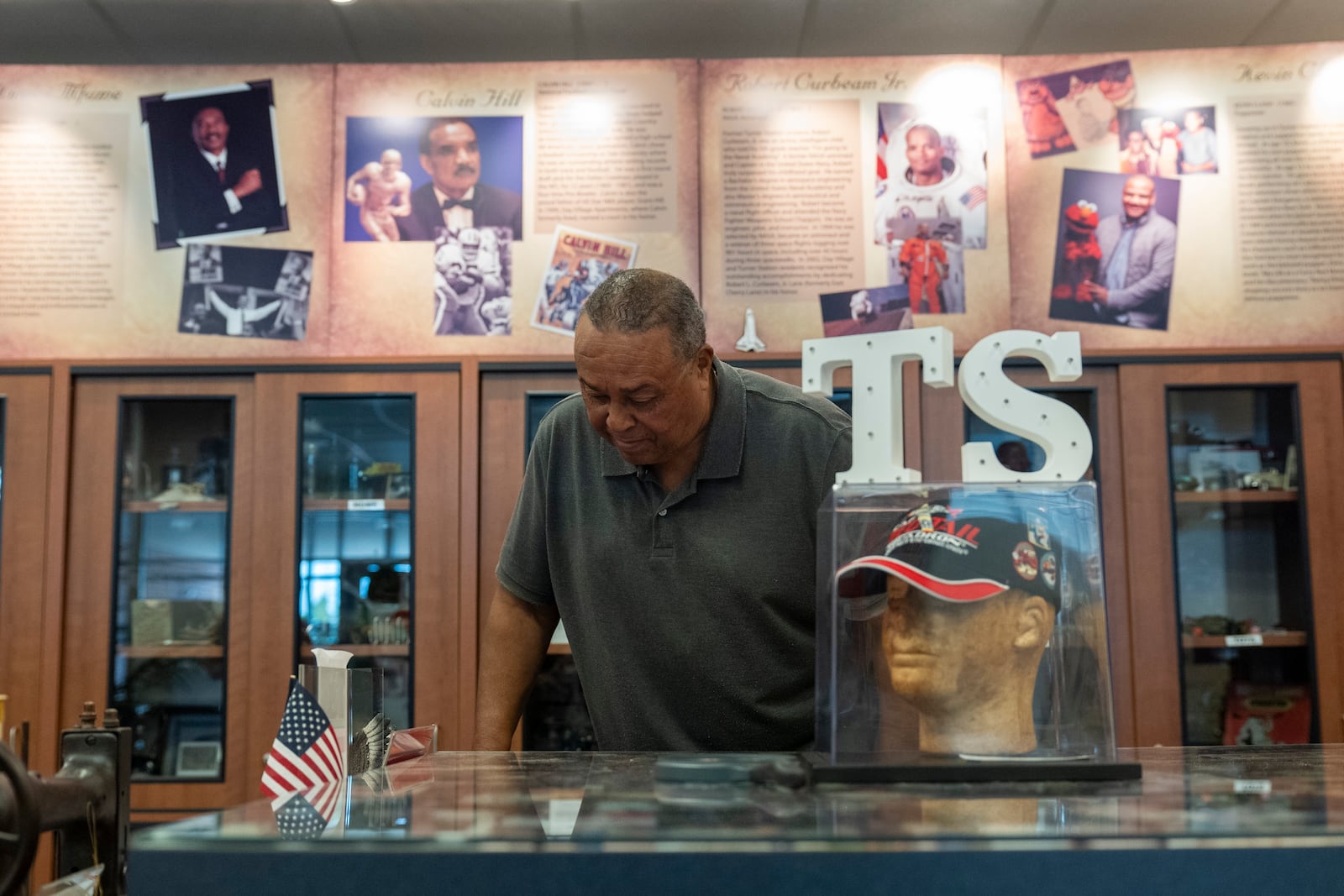 Vernon Banks, a volunteer at the Turner Station History Center, looks at photos in the community museum, Friday, Aug. 16, 2024, in Turner Station, Md. (AP Photo/Stephanie Scarbrough)