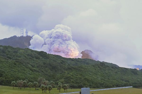 Smoke billows during a combustion test of an engine for new small Japanese rocket Epsilon S at Tanegashima Space Center, Kagoshima prefecture, southern Japan, Tuesday, Nov. 26, 2024. (Kyodo News via AP)