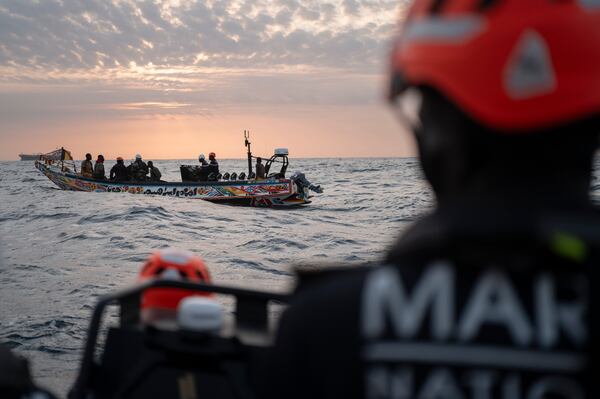 Senegalese sailors in their zodiac approach a fishermen's pirogue to check during a mission to search for illegal migrant boats near the coast of Dakar, Senegal, Saturday, Nov.16, 2024. (AP Photo/Sylvain Cherkaoui)