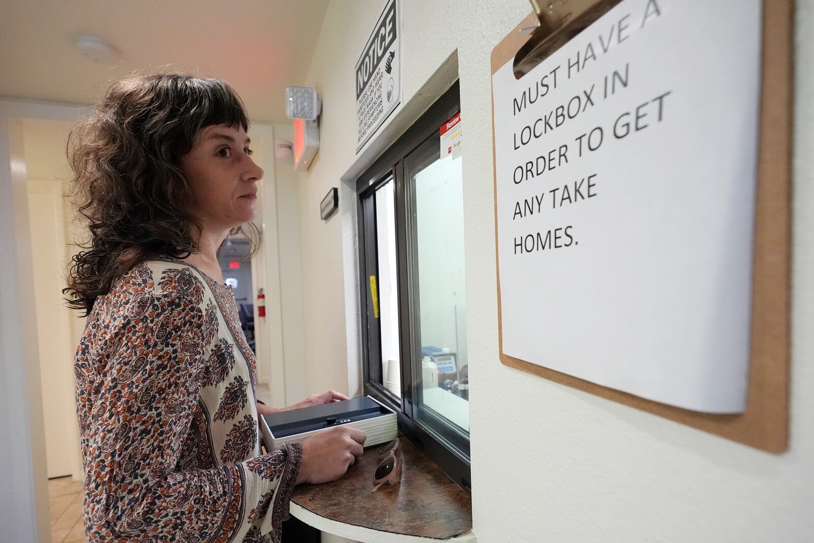 Methadone patient Irene Garnett, 44, of Phoenix, waits for her medication at a clinic in Scottsdale, Ariz., on Monday, Aug. 26, 2024. (AP Photo/Ross D. Franklin)