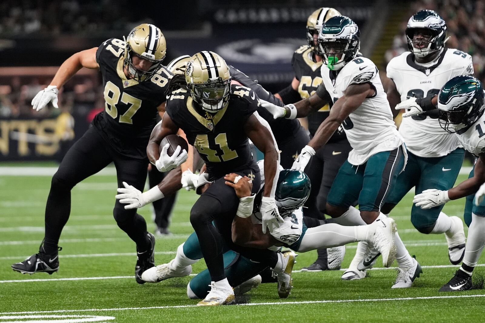 New Orleans Saints running back Alvin Kamara (41) is brought down by Philadelphia Eagles linebacker Nolan Smith Jr. (3) in the first half of an NFL football game in New Orleans, Sunday, Sept. 22, 2024. (AP Photo/Gerald Herbert)