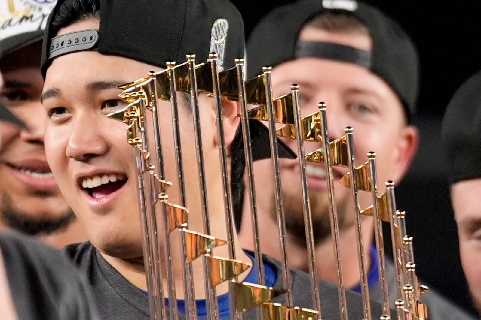 Los Angeles Dodgers' Shohei Ohtani celebrates with the trophy after their win against the New York Yankees in Game 5 to win the baseball World Series, Thursday, Oct. 31, 2024, in New York. (AP Photo/Ashley Landis)