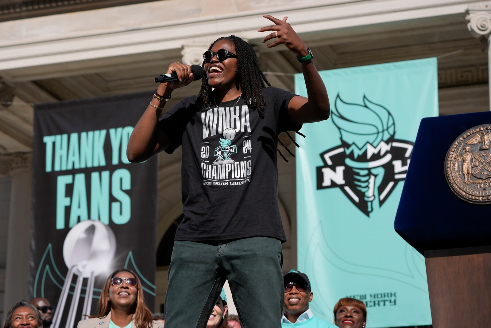 New York Liberty MVP Jonquel Jones celebrates during a ceremony after a parade in honor of the Liberty's WNBA basketball championship at City Hall in New York, Thursday, Oct. 24, 2024. (AP Photo/Seth Wenig)