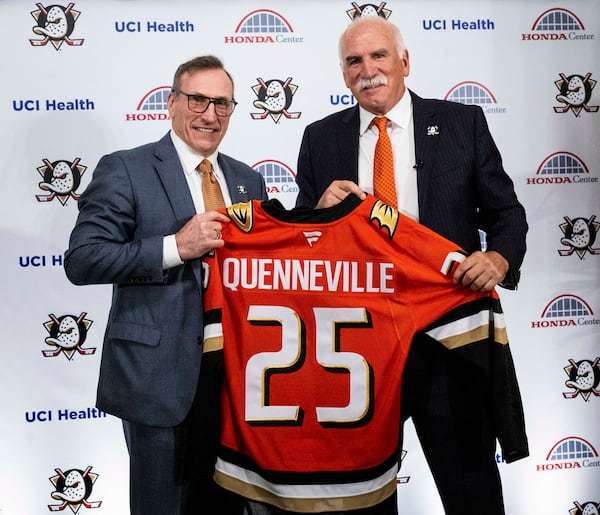 Anaheim Ducks general manager Pat Verbeek, left, and new head coach Joel Quenneville pose with jersey during an NHL hockey press conference in Anaheim, Calif., Thursday, May 8, 2025. (Paul Bersebach/The Orange County Register via AP)