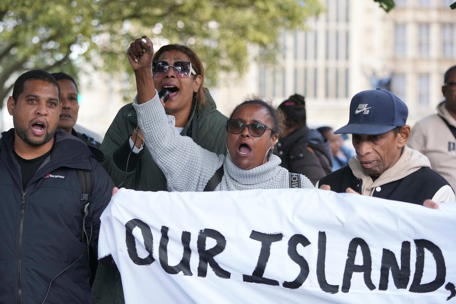 Chagossians attend a protest to response the U.K. announcement to agree to hand sovereignty of the long-contested Chagos Islands to Mauritius and against their "Exclusion" from Chagos negotiations, outside the House of Parliament, in London, Monday, Oct. 7, 2024. (AP Photo/Kin Cheung)