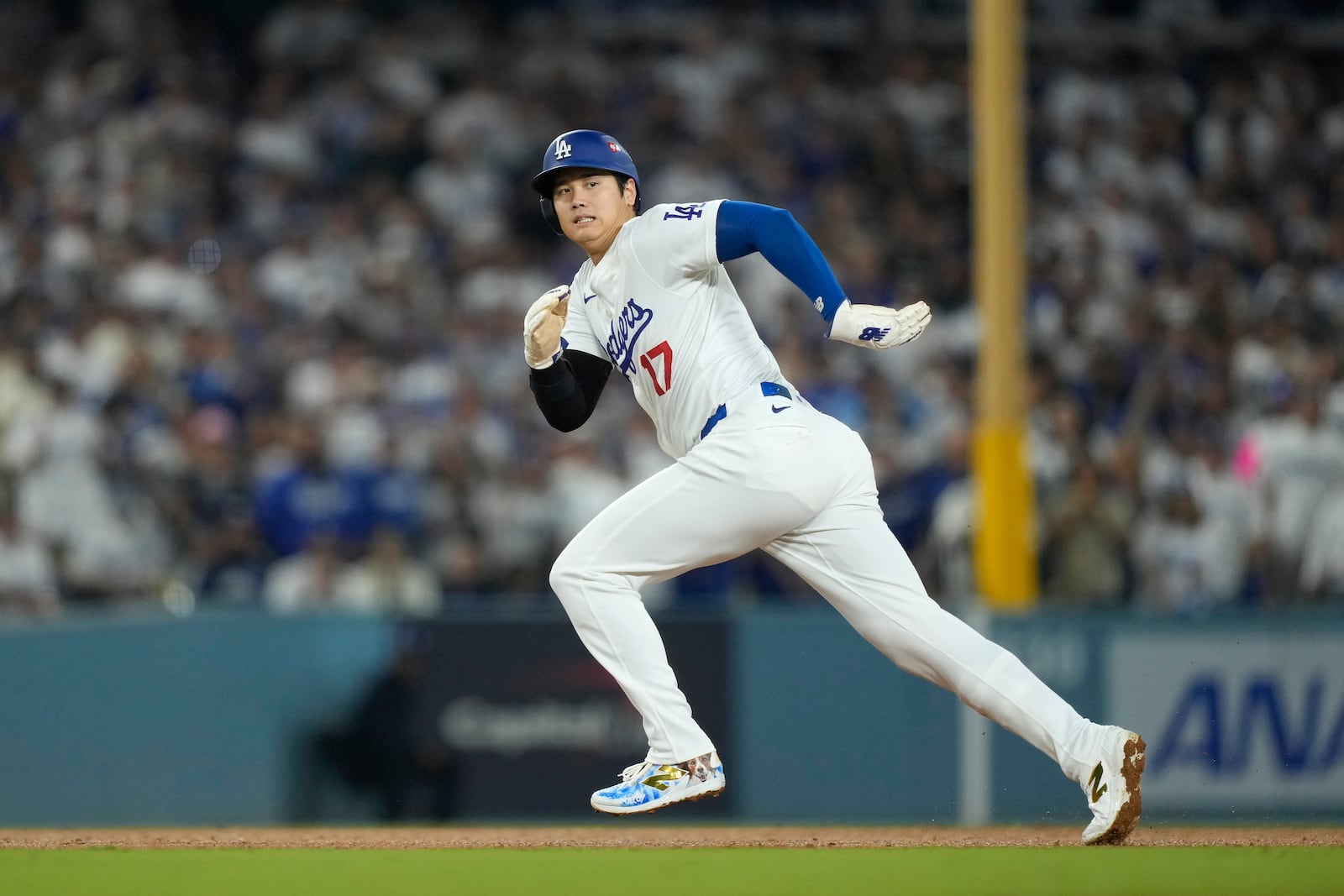 Los Angeles Dodgers' Shohei Ohtani runs from second to third base during the fourth inning in Game 1 of baseball's NL Division Series against the San Diego Padres, Saturday, Oct. 5, 2024, in Los Angeles. (AP Photo/Mark J. Terrill)