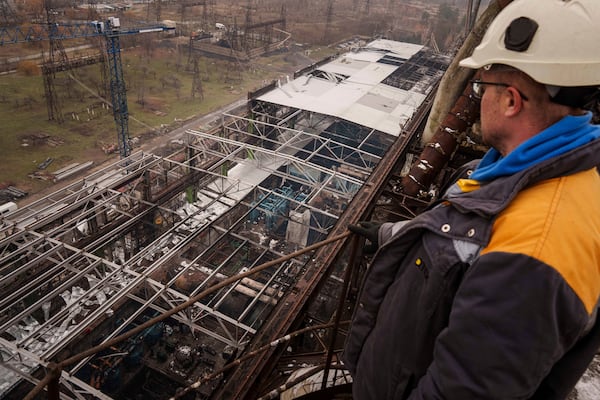 A worker looks on a production hall after a recent Russian missile attack at DTEK's power plant in Ukraine, Nov. 28, 2024. (AP Photo/Evgeniy Maloletka)