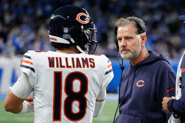 Chicago Bears quarterback Caleb Williams (18) talks with head coach Matt Eberflus during the second half of an NFL football game in Detroit, Thursday, Nov. 28, 2024. (AP Photo/Duane Burleson)