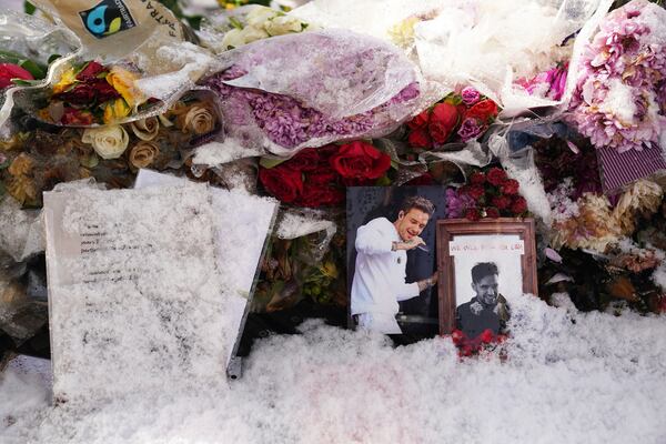 Floral tributes to singer Liam Payne at a memorial in West Park in his hometown of Wolverhampton, England, Wednesday, Nov. 20, 2024. (Jacob King/PA via AP)