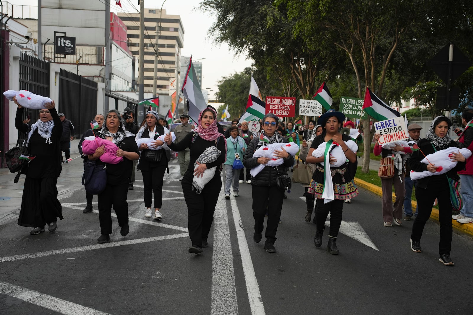 Pro-Palestinian demonstrators march in support of the Palestinians, in Lima, Peru, Monday, Oct. 7, 2024. (AP Photo/Guadalupe Pardo)