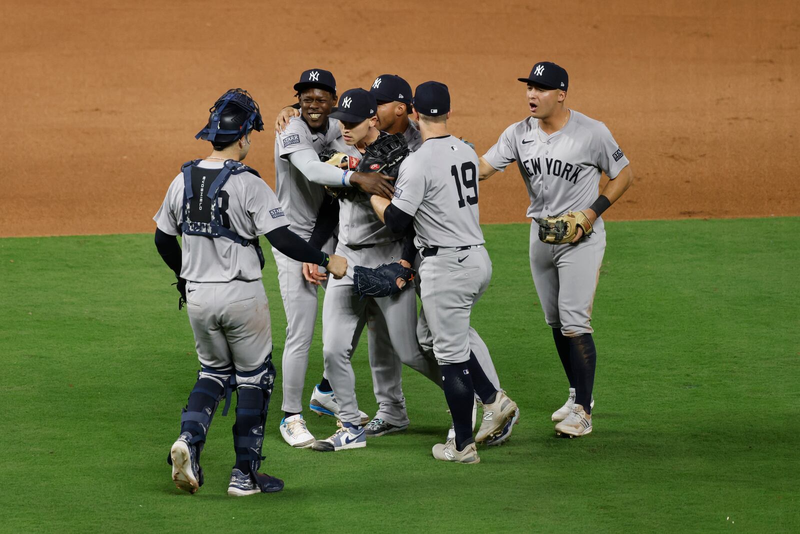 Members of the New York Yankees celebrate a 3-1 victory over the Kansas City Royals in Game 4 of an American League Division baseball playoff series Thursday, Oct. 10, 2024, in Kansas City, Mo. (AP Photo/Colin Braley)