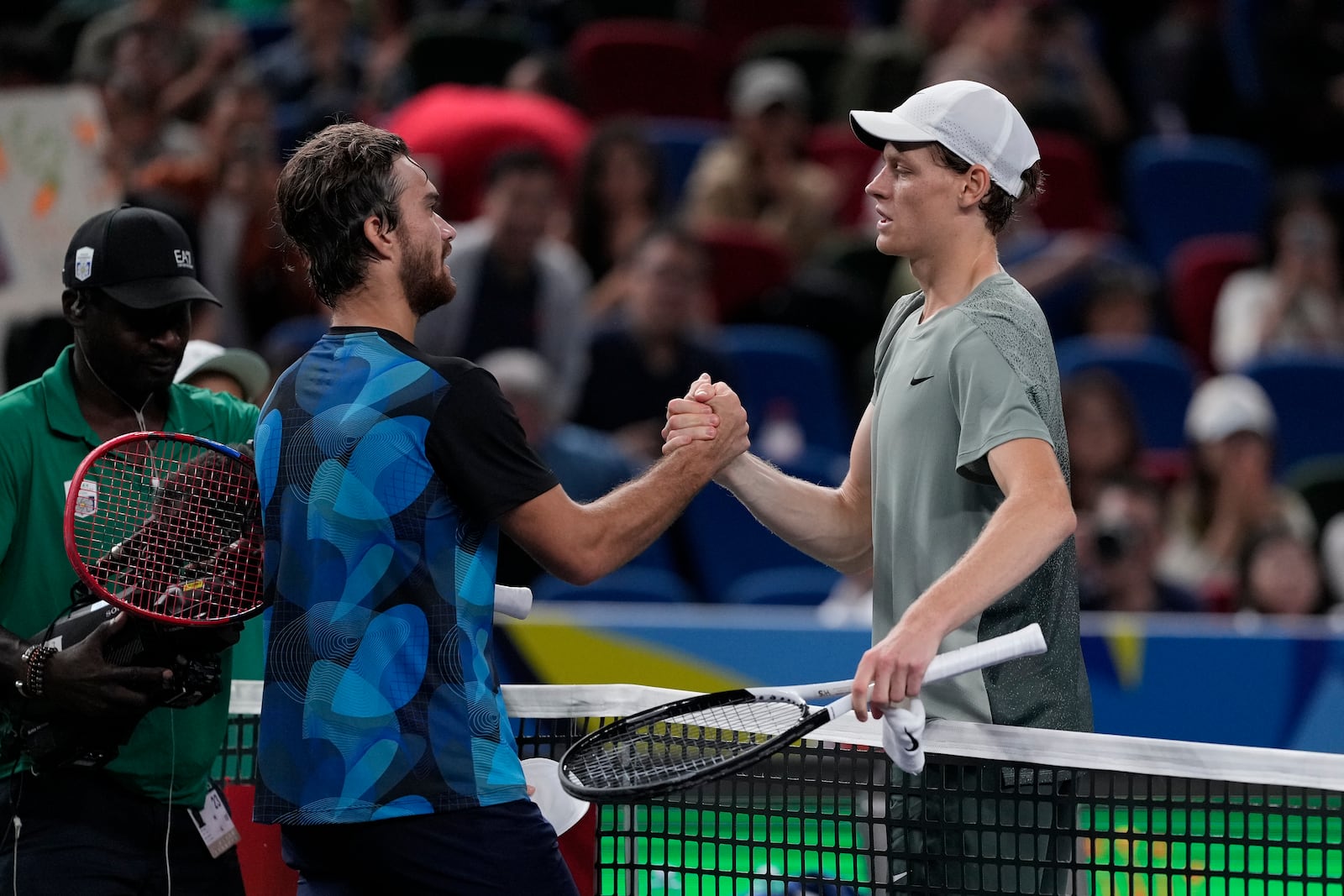 Jannik Sinner of Italy, right, shakes hands with Tomas Machac of the Czech Republic after winning in their men's singles semifinals match of the Shanghai Masters tennis tournament at Qizhong Forest Sports City Tennis Center in Shanghai, China, Saturday, Oct. 12, 2024. (AP Photo/Andy Wong)