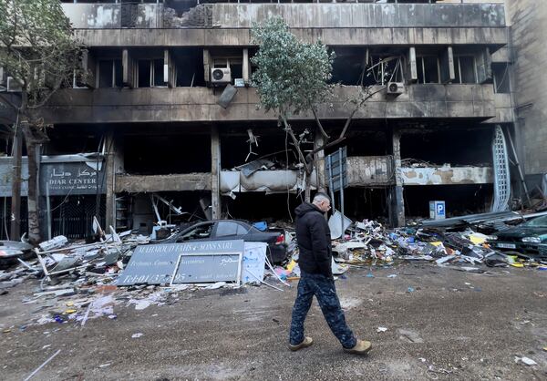 A Lebanese policeman walks in front of destroyed shops that were hit Sunday evening by an Israeli airstrike in central Beirut, Lebanon, Monday, Nov. 18, 2024. (AP Photo/Hussein Malla)