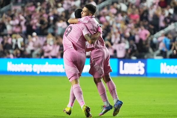 Inter Miami defender Jordi Alba, right, celebrates with forward Luis Suárez (9) after scoring a goal during the first half of a CONCACAF Champions Cup second-leg semifinal soccer match against the Vancouver Whitecaps, Wednesday, April 30, 2025, in Fort Lauderdale, Fla. (AP Photo/Lynne Sladky)