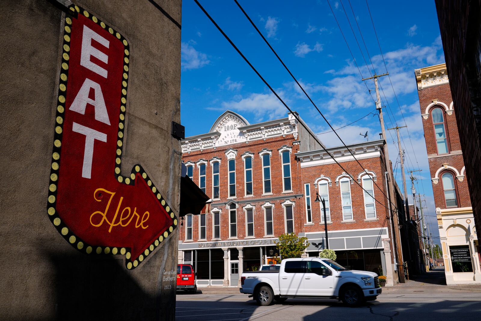 Signage for a restaurant located among some of the historic buildings on Main Street in the downtown area in Delphi, Ind., Tuesday, Oct. 1, 2024. (AP Photo/Michael Conroy)