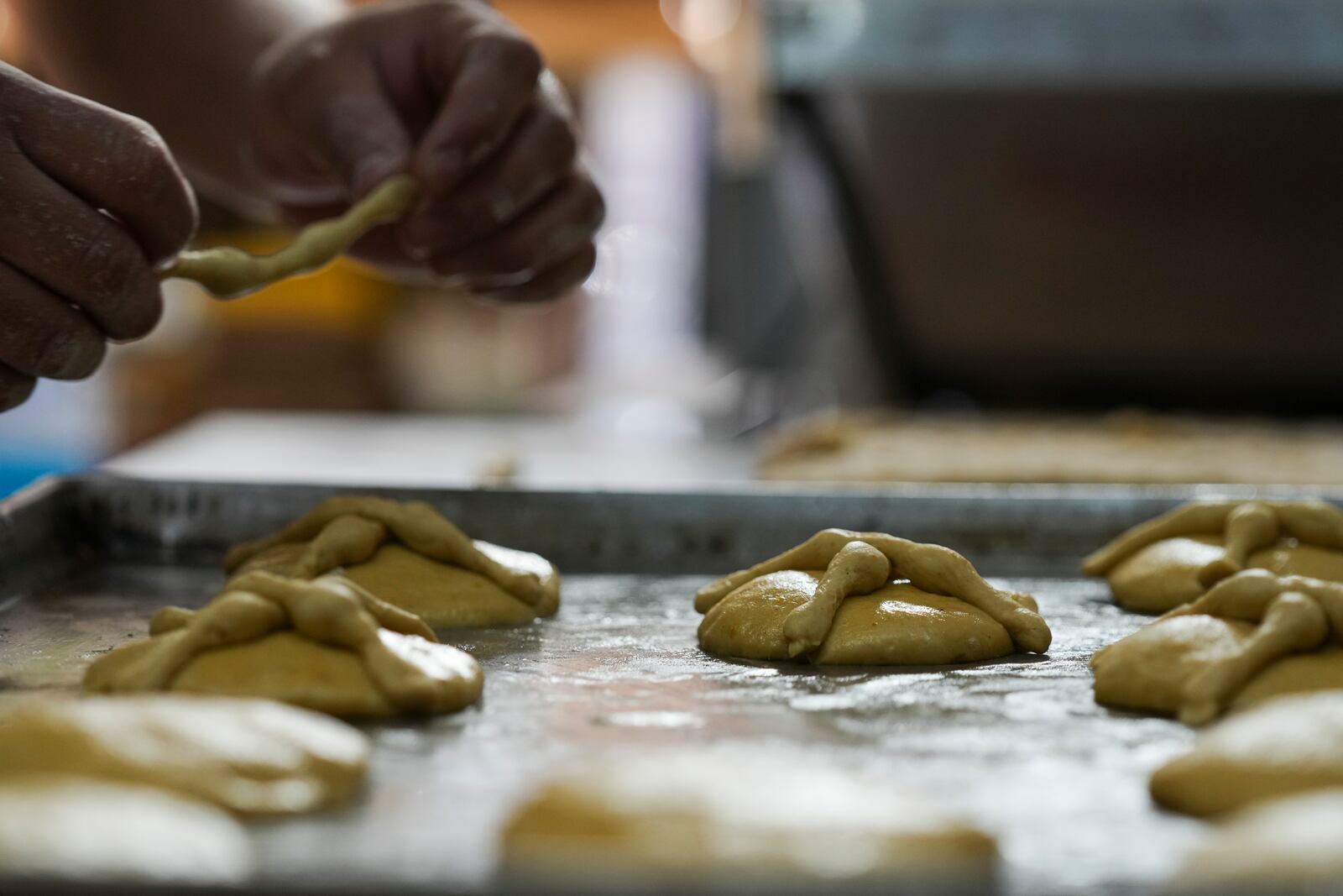 Victor Silverio prepares pan de muerto, or "bread of the dead," traditional for Mexico's Day of the Dead, at a bakery in the San Rafael neighborhood of Mexico City, Thursday, Oct. 17, 2024. (AP Photo/Fernando Llano)