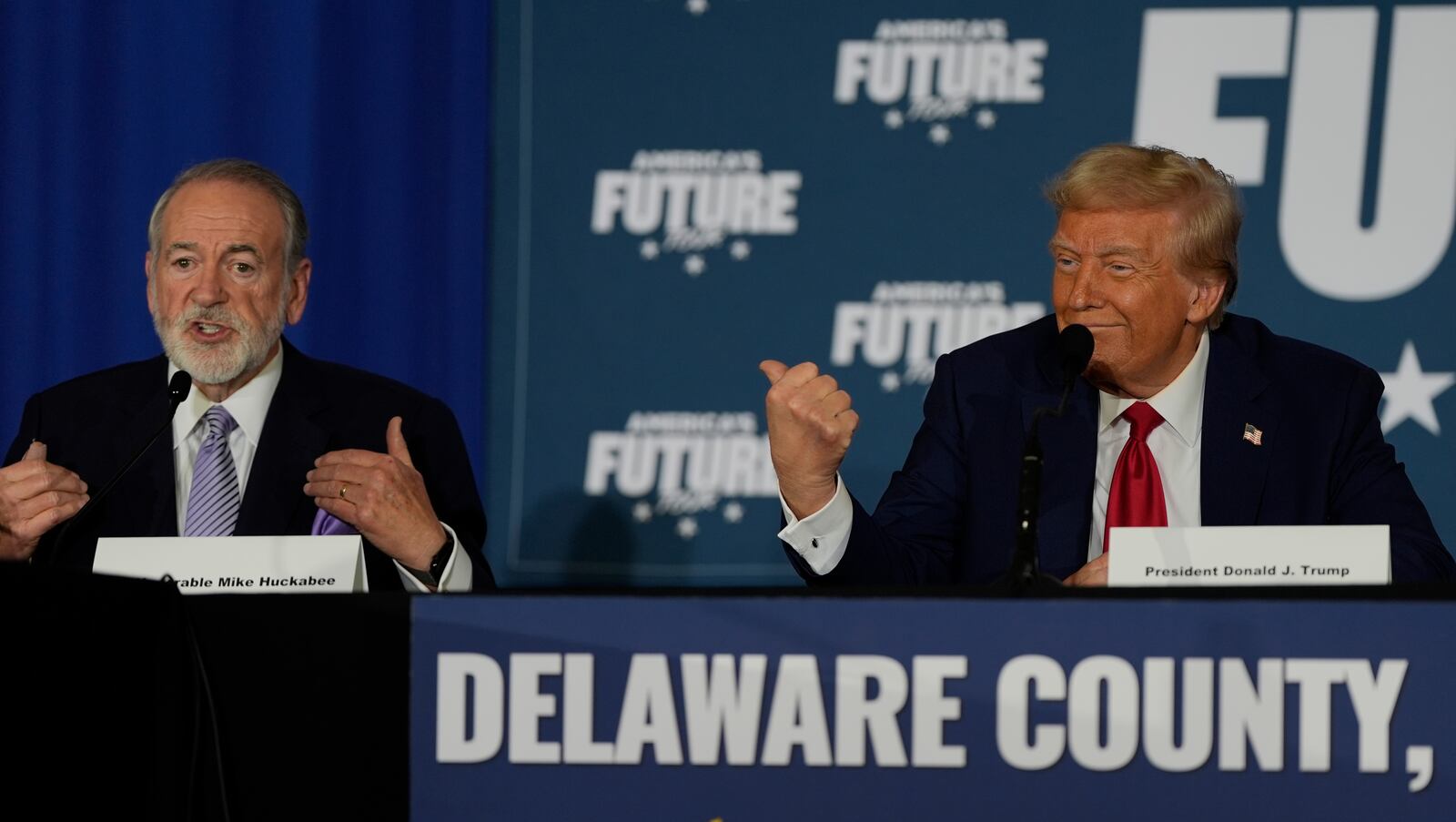 Republican presidential nominee former President Donald Trump gestures as former Arkansas Gov. Mike Huckabee speaks during a roundtable at the Drexelbrook Catering & Event Center, Tuesday, Oct. 29, 2024, in Drexel Hill, Pa. (AP Photo/Julia Demaree Nikhinson)