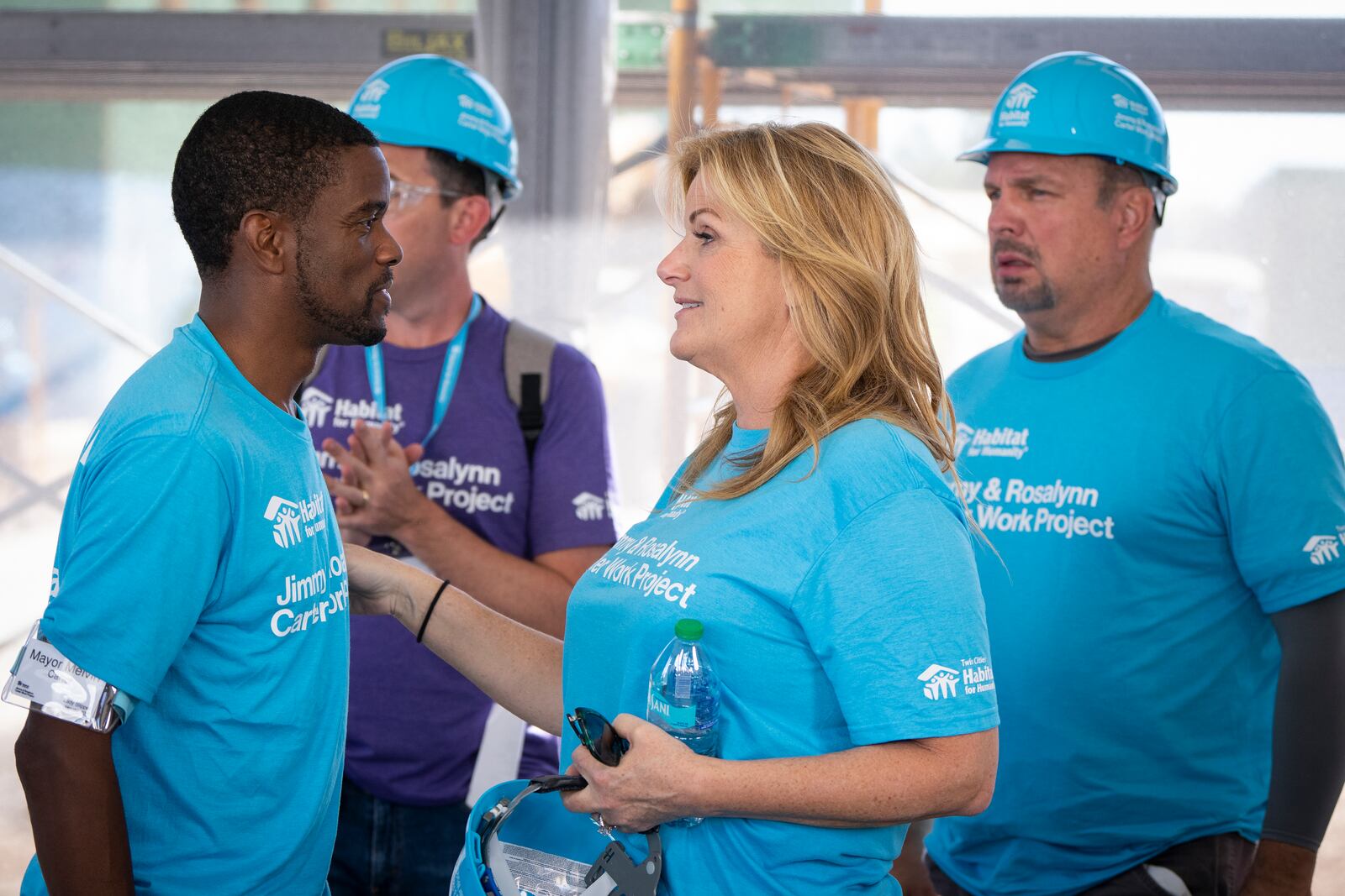 St. Paul Mayor Melvin Carter, from left, talks with Trisha Yearwood and Garth Brooks after a press conference at Twin Cities Habitat for Humanity's 2024 Jimmy & Rosalynn Carter Work Project at the site of the former Hillcrest Golf Course in St. Paul, Minn. on Monday, Sept. 30, 2024. (Leila Navidi /Star Tribune via AP)