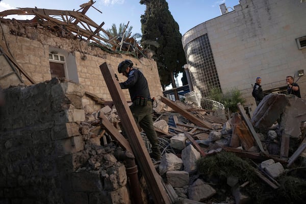 Israeli security forces check a house hit by a rocket fired from Lebanon on Saturday, in Haifa, Israel, Sunday, Nov. 17, 2024. (AP Photo/Ohad Zwigenberg)