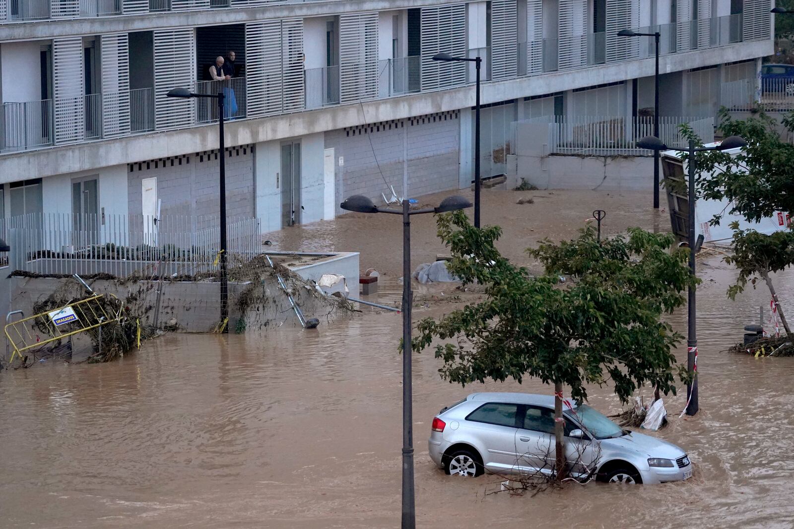 Cars are trapped by flooding in Valencia, Wednesday, Oct. 30, 2024. (AP Photo/Alberto Saiz)