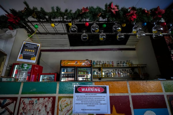 A notice displayed at the bar of Nana Backpack hostel in Vang Vieng, Laos, Tuesday, Nov. 19, 2024. (AP Photo/Anupam Nath)