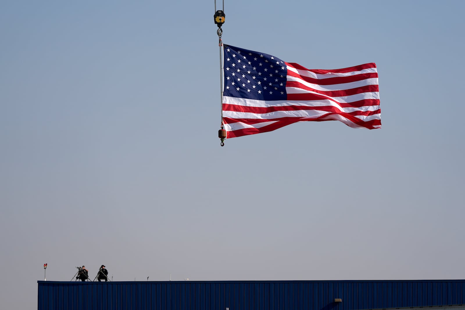 Law enforcement snipers sit on a roof before Republican presidential nominee former President Donald Trump arrives to speak at a campaign rally at Dodge County Airport, Sunday, Oct. 6, 2024, in Juneau, Wis. (AP Photo/Julia Demaree Nikhinson)