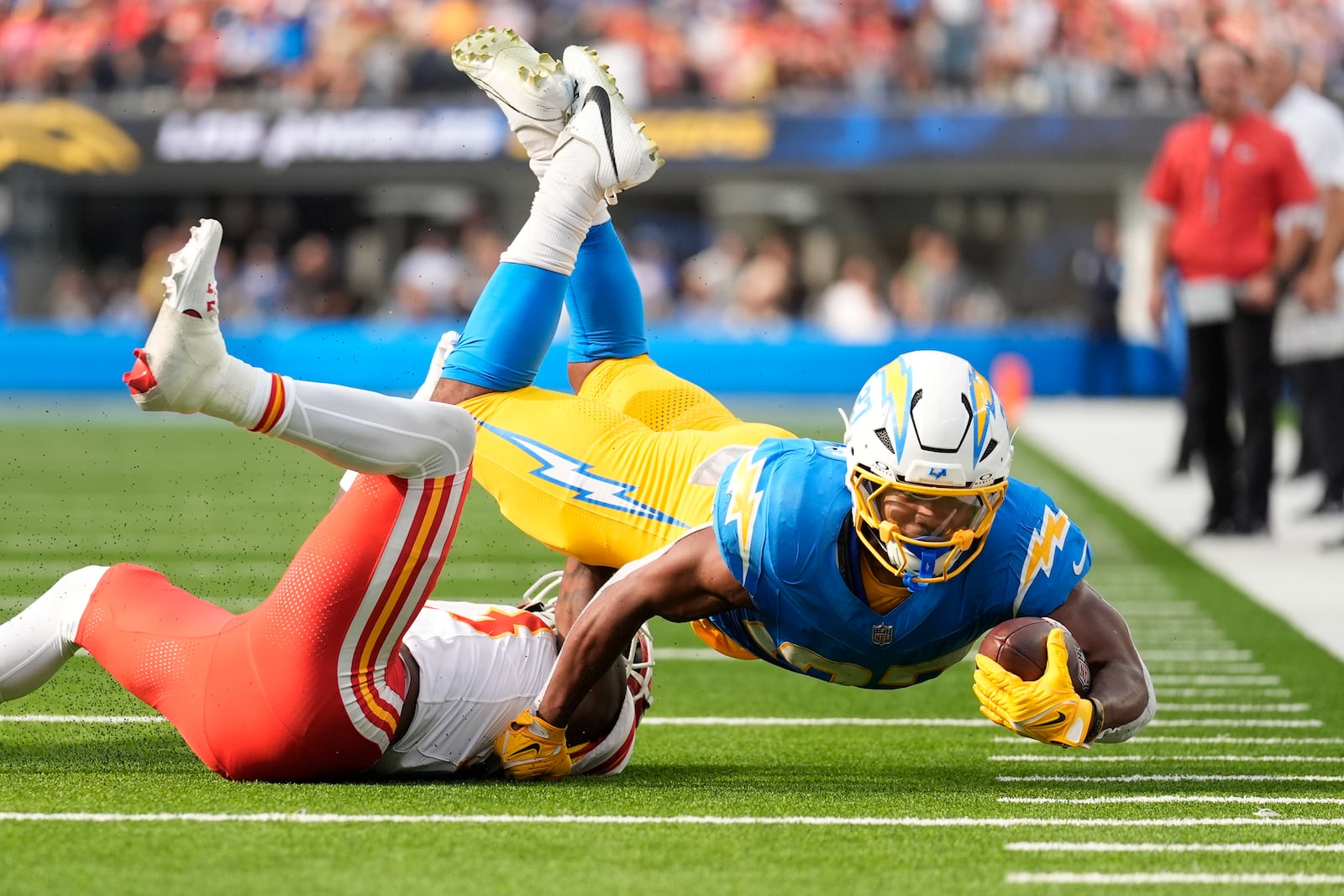 Los Angeles Chargers running back J.K. Dobbins, right, struggles for yardage as Kansas City Chiefs safety Nazeeh Johnson, left, defends during the second half of an NFL football game Sunday, Sept. 29, 2024, in Inglewood, Calif. (AP Photo/Ashley Landis)