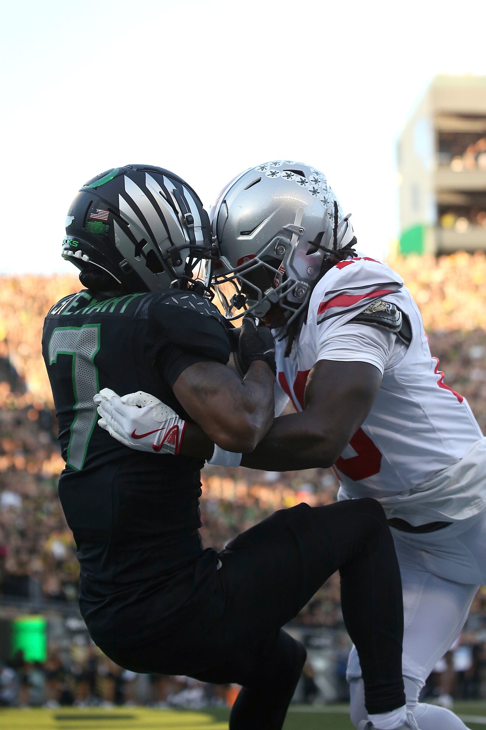 Oregon wide receiver Evan Stewart (7) catches the ball for a touchdown against Ohio State cornerback Denzel Burke (10) during an NCAA college football game, Saturday, Oct. 12, 2024, in Eugene, Ore. (AP Photo/Lydia Ely)