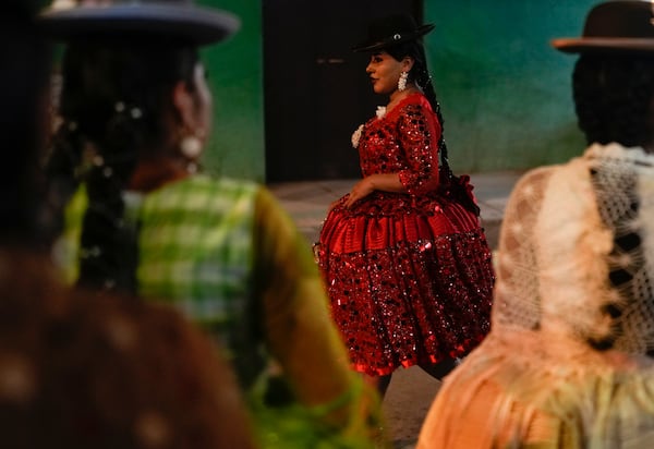 Women model creations by a local designer at a Chola fashion show, promoting the Andean style and beauty of Aymara women, in Viacha, Bolivia, Friday, Nov. 29, 2024. (AP Photo/Juan Karita)