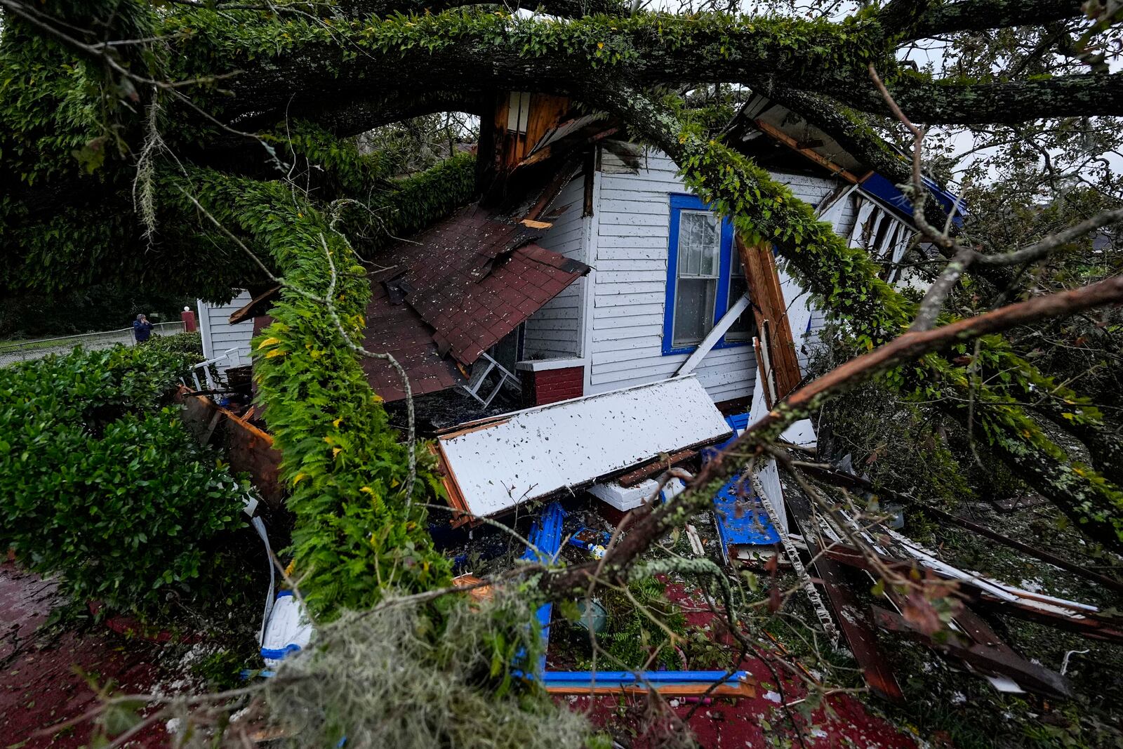 FILE - A damaged 100-year-old home is seen after an Oak tree landed on it after Hurricane Helene moved through the area, Sept. 27, 2024, in Valdosta, Ga. (AP Photo/Mike Stewart, File)