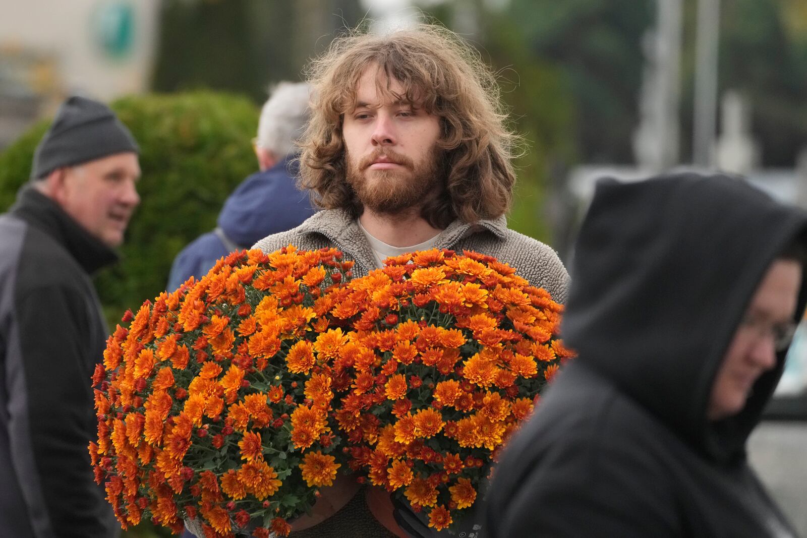 People prepare for All Saints' Day at the cemetery in Zakroczym, near Warsaw, Poland, Wednesday, Oct. 30, 2024. (AP Photo/Czarek Sokolowski)