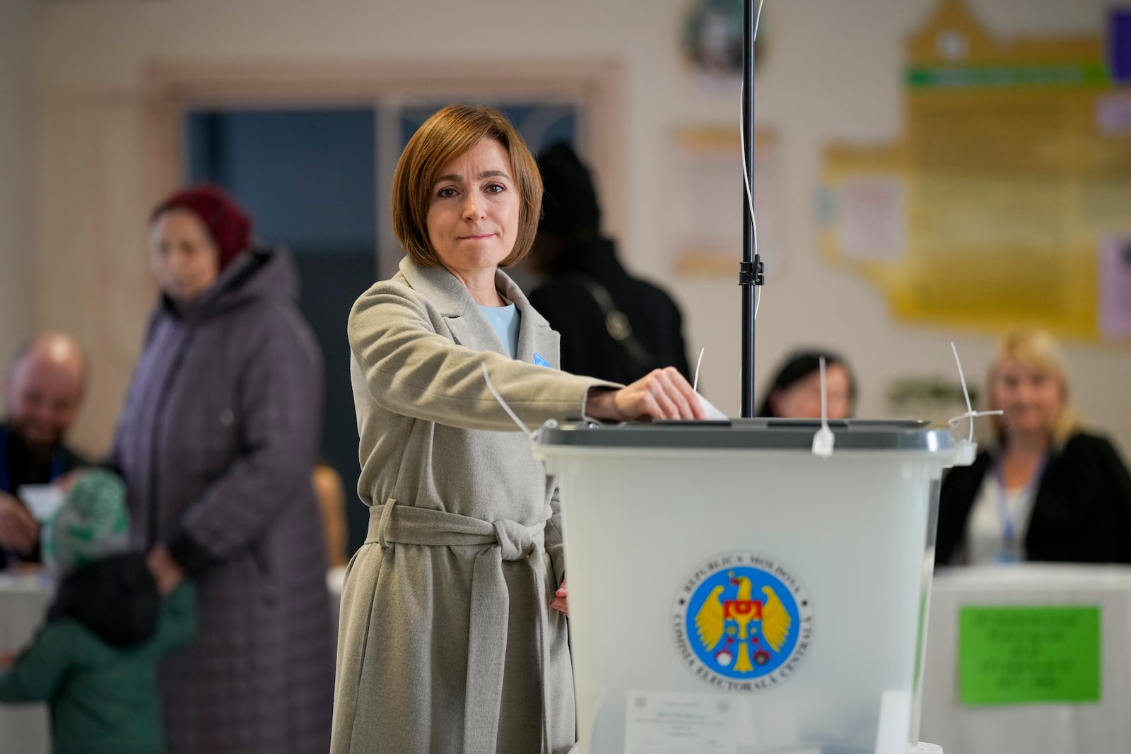 Moldova's President Maia Sandu prepares to cast her vote during a presidential election runoff, in Chisinau, Moldova, Sunday, Nov. 3, 2024. (AP Photo/Vadim Ghirda)