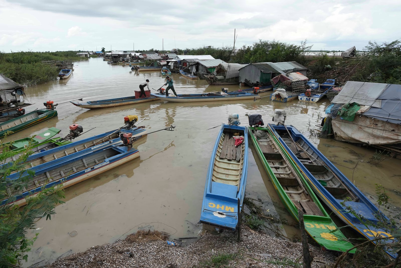 Boats of fisherfolk are anchored by a floating village, by the Tonle Sap in Kampong Chhnang province, Cambodia, Thursday, Aug. 1, 2024, (AP Photo/Heng Sinith)