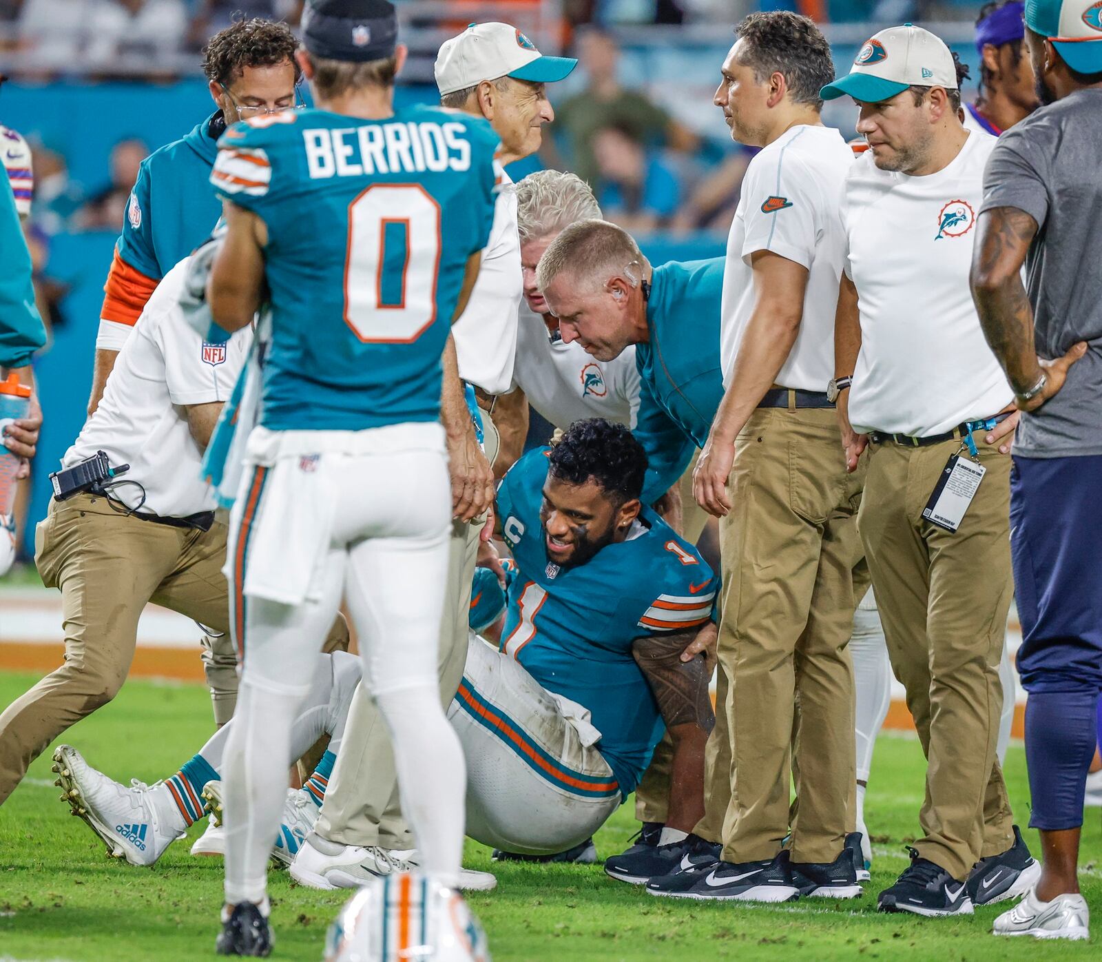 Miami Dolphins quarterback Tua Tagovailoa (1) is assisted after an injury in the third quarter of an NFL football game against the Buffalo Bills in Miami Gardens, Fla., Thursday, Sept. 12, 2024. (Al Diaz/Miami Herald via AP)