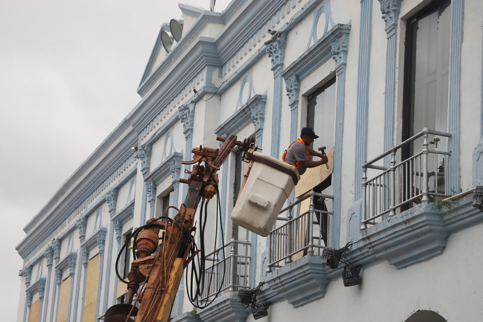 A man boards up a government building to protect it from Hurricane Milton, in Progreso, Yucatan state, Mexico, Monday, Oct. 7, 2024. (AP Photo/Martin Zetina)