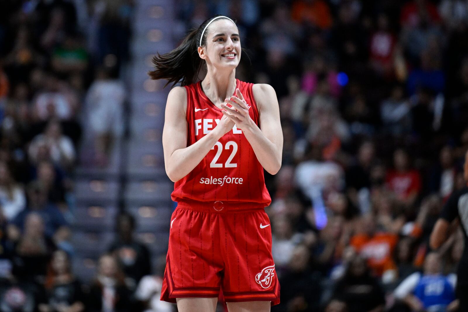 Indiana Fever guard Caitlin Clark (22) reacts during a first-round WNBA basketball playoff game against the Connecticut Sun, Wednesday, Sept. 25, 2024, in Uncasville, Conn. (AP Photo/Jessica Hill)